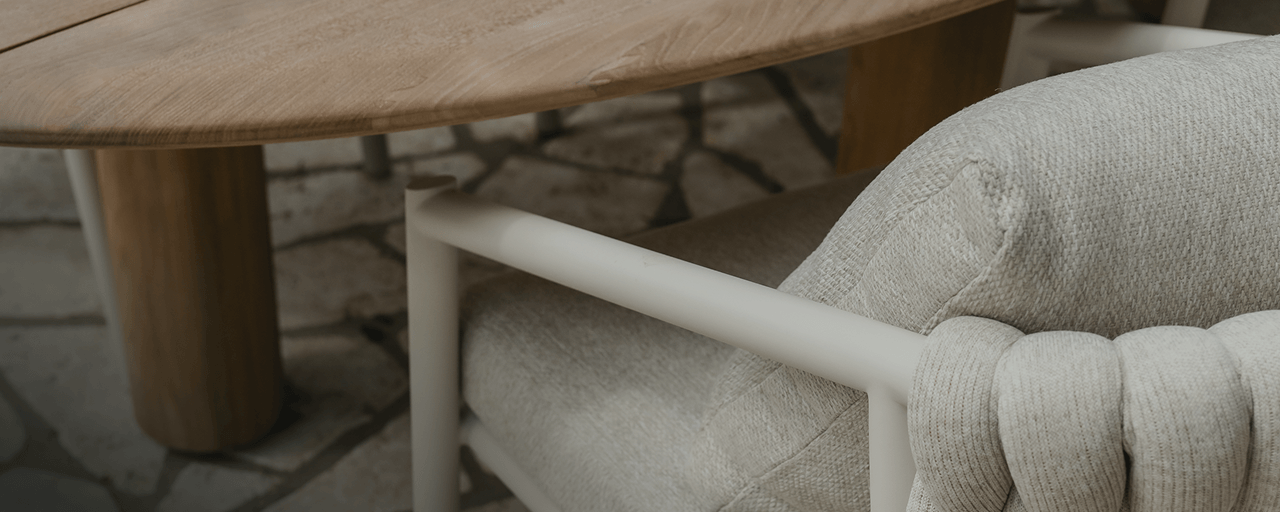 Close-up of luxury dining chair and a wooden outdoor dining table