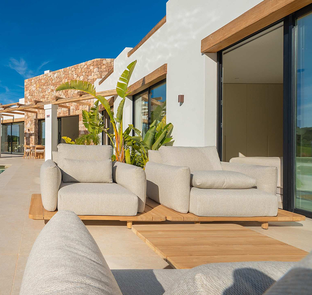 Two comfortable lounge chairs in luxury villa garden
