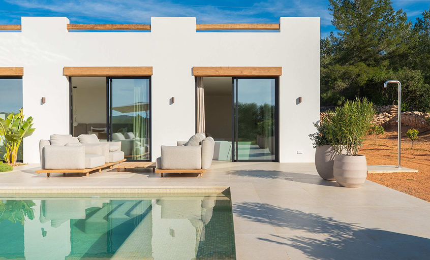 Luxury white villa with beige pottery, outdoor furniture and a swimming pool