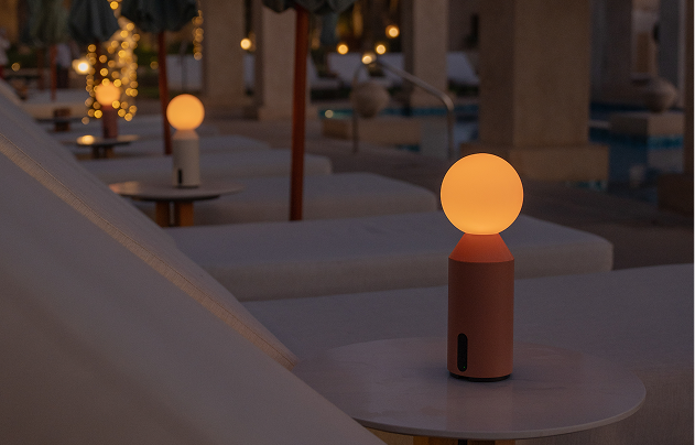 Designer table lamp on side table next to outdoor lounge